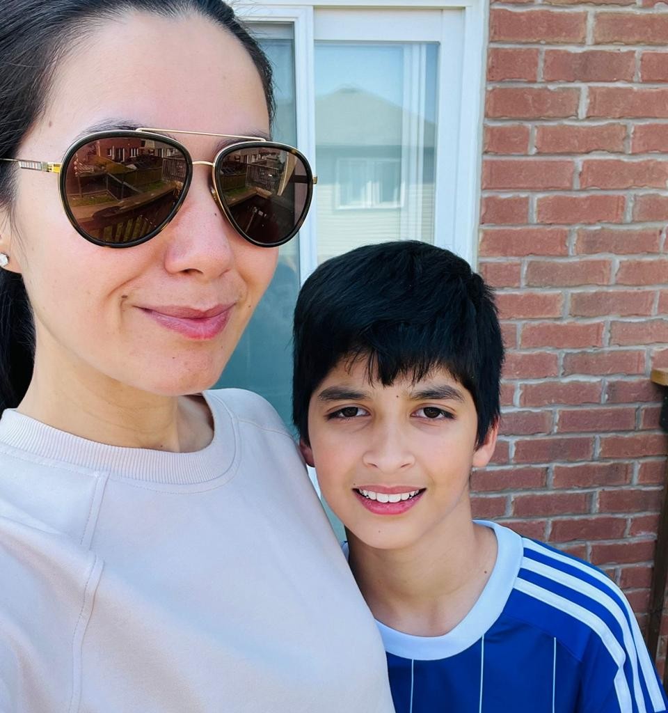 Ameera, founder of Sprinkles by Ameera, smiling with her son